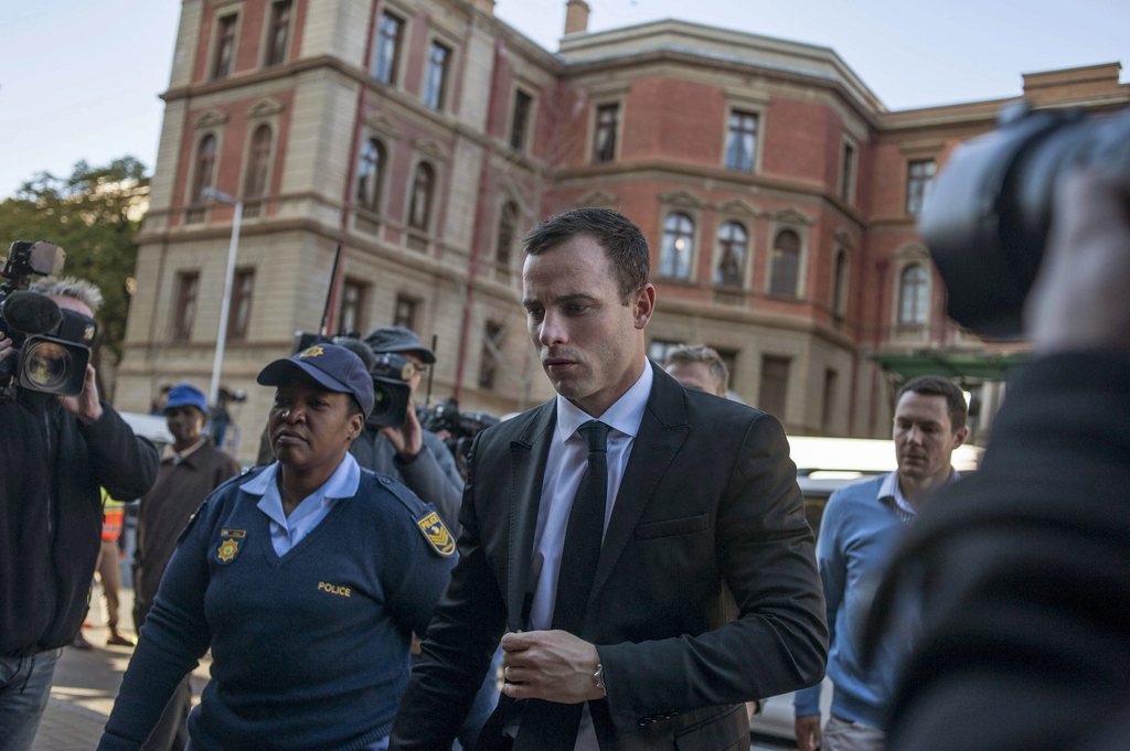 Oscar Pistorius sortant du tribunal de Pretoria ce lundi, escorté par deux membres de la police.