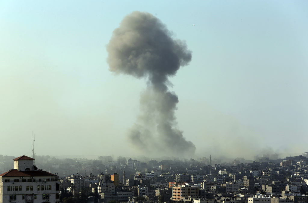 Smoke from an Israeli strike rises in the air over Gaza City, Saturday, July 26, 2014. Israel-Hamas fighting looked headed for escalation after U.S. Secretary of State John Kerry failed Friday to broker a weeklong truce as a first step toward a broader deal. Hours after the U.S.-led efforts stalled, the two sides agreed to a 12-hour humanitarian cease-fire to begin Saturday. However, the temporary lull was unlikely to change the trajectory of the current hostilities amid ominous signs that the Gaza war is spilling over into the West Bank. (AP Photo/Lefteris Pitarakis)