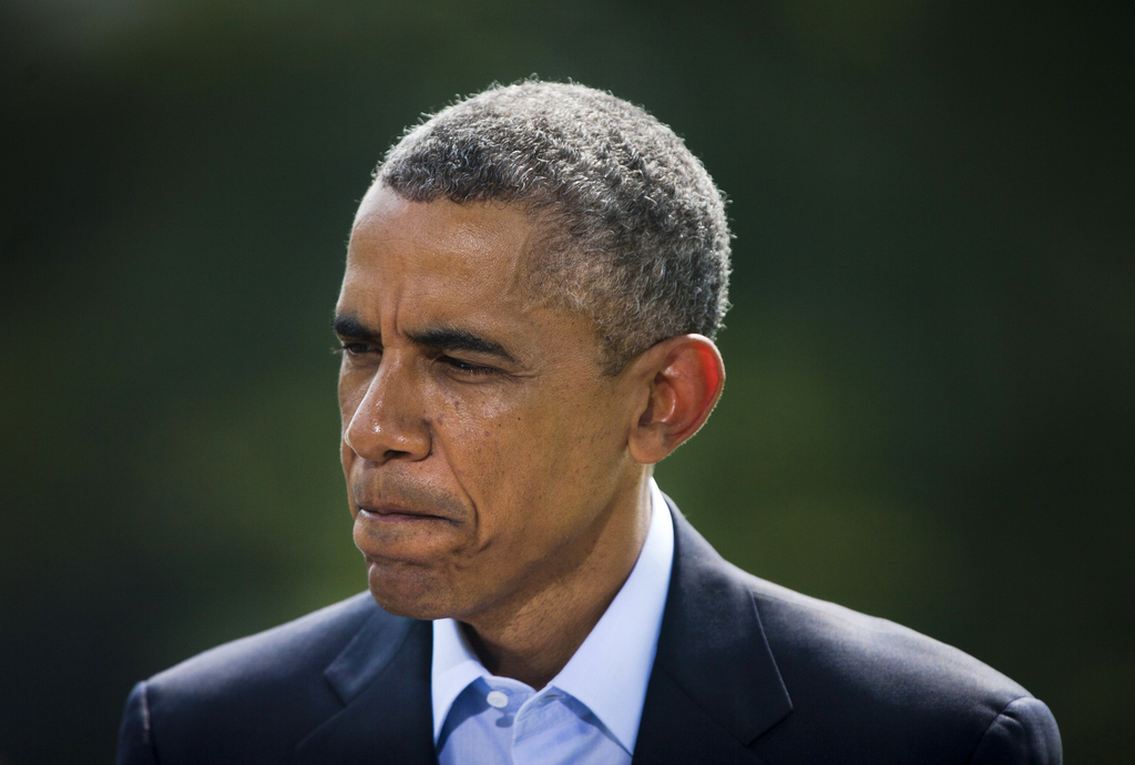 President Barack Obama pauses as he speaks on the South Lawn of the White House in Washington, Saturday, Aug. 9, 2014, about the ongoing situation in Iraq before his departure on Marine One for a vacation in Martha's Vineyard. Obama said that airstrikes he ordered in northern Iraq have destroyed arms and equipment held by Islamic State forces whose rapid advance has surpassed U.S. intelligence estimates. (AP Photo/Pablo Martinez Monsivais)