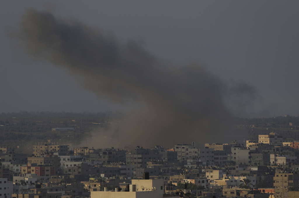 Smoke from an Israeli strike rises over Gaza City, Gaza Strip, Sunday, Aug. 10, 2014. Egyptian-brokered talks between Israel and Hamas on a new border deal for Gaza were thrown into doubt Saturday after senior officials said an Israeli team would not rejoin negotiations in Cairo unless rocket fire from Gaza stops. (AP Photo/Lefteris Pitarakis)