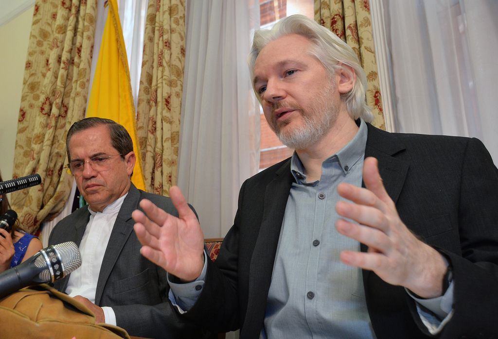 Ecuador's Foreign Minister Ricardo Patino, left, and WikiLeaks founder Julian Assange speak during a press conference inside the Ecuadorian Embassy in London, where he confirmed he "will be leaving the embassy soon", Monday Aug. 18, 2014.  The Australian Assange fled to the Ecuadorian Embassy in 2012 to escape extradition to Sweden, where he is wanted over allegations of sex crimes. (AP Photo / John Stillwell, POOL)