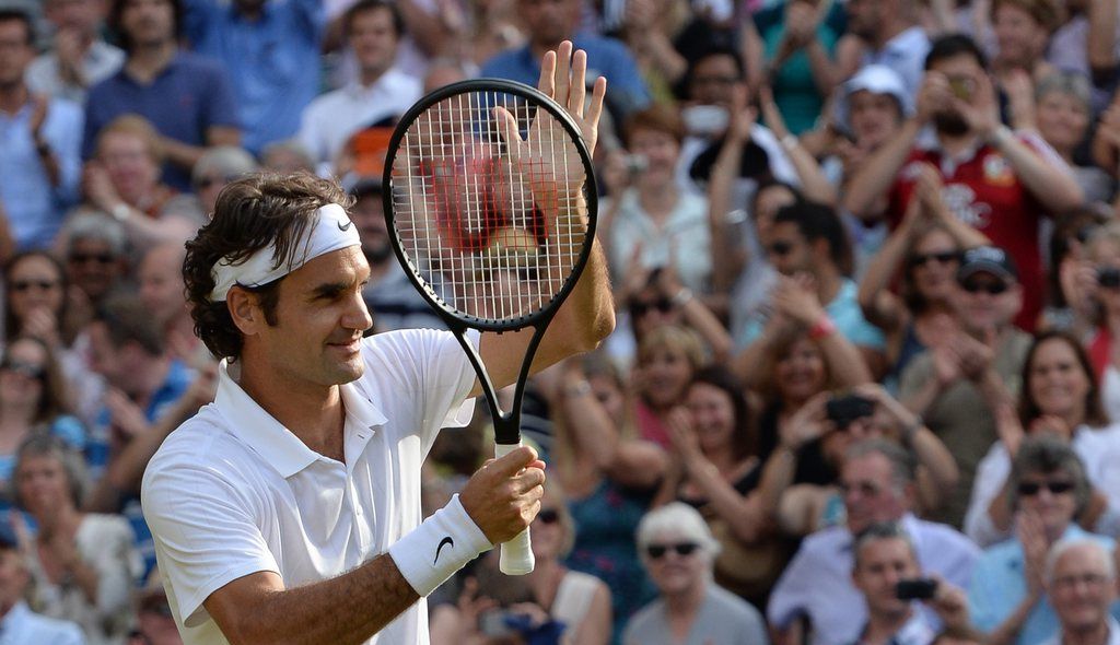 epa04298900 Roger Federer of Switzerland celebrates his win against Milos Raonic of Canada in their semi-final match of the Wimbledon Championships at the All England Lawn Tennis Club, in London, Britain, 04 July 2014.  EPA/ANDY RAIN