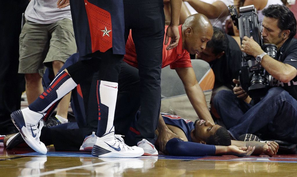 Indiana Pacers' Paul George lies on the court after he was injured during the USA Basketball Showcase game Friday, Aug. 1, 2014, in Las Vegas. (AP Photo/John Locher)