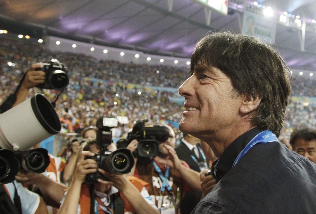 Germany's head coach Joachim Loew looks into the stands during a victory lap after the World Cup final soccer match between Germany and Argentina at the Maracana Stadium in Rio de Janeiro, Brazil, Sunday, July 13, 2014. Germany won the match 1-0.   (AP Photo/Matthias Schrader)