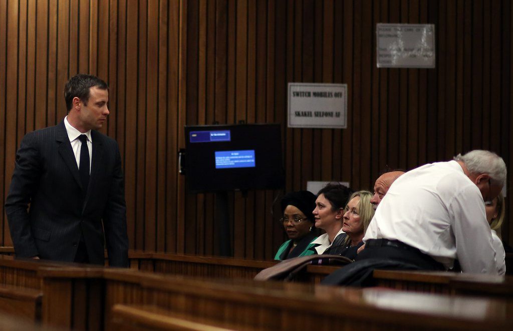 epa04345432 South African Paralympic athlete Oscar Pistorius (L) stands near Reeva Steenkamp's mother June (3-R) and father Barry (2-R) during his ongoing murder trial, in Pretoria, South Africa, 08 August 2014. The defense will give final argument as Pistorius stands trial for the premeditated murder of his model girlfriend Reeva Steenkamp in February 2013.  EPA/THEMA HADEBE / POOL