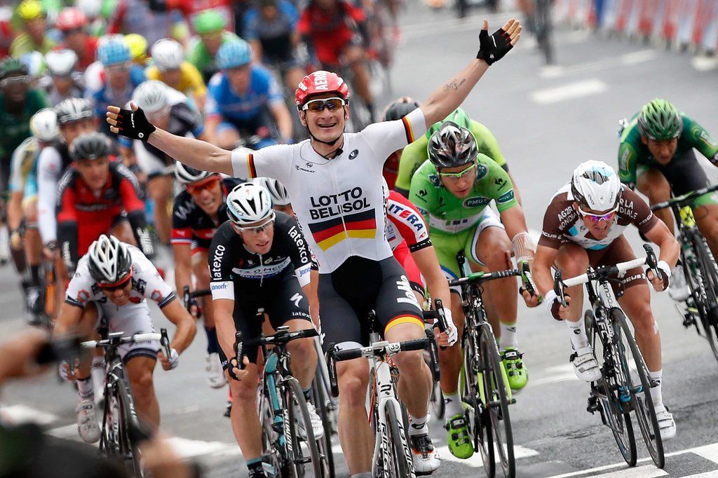 epa04309805 Lotto Belisol procycling team rider Andre Greipel (C) of Germany celebrates as he crosses the finish line to win the 6th stage of the 101st Tour de France cycling race, 194km between Arras and Reims, France, 10 July 2014.  EPA/BAS CZERWINSKI