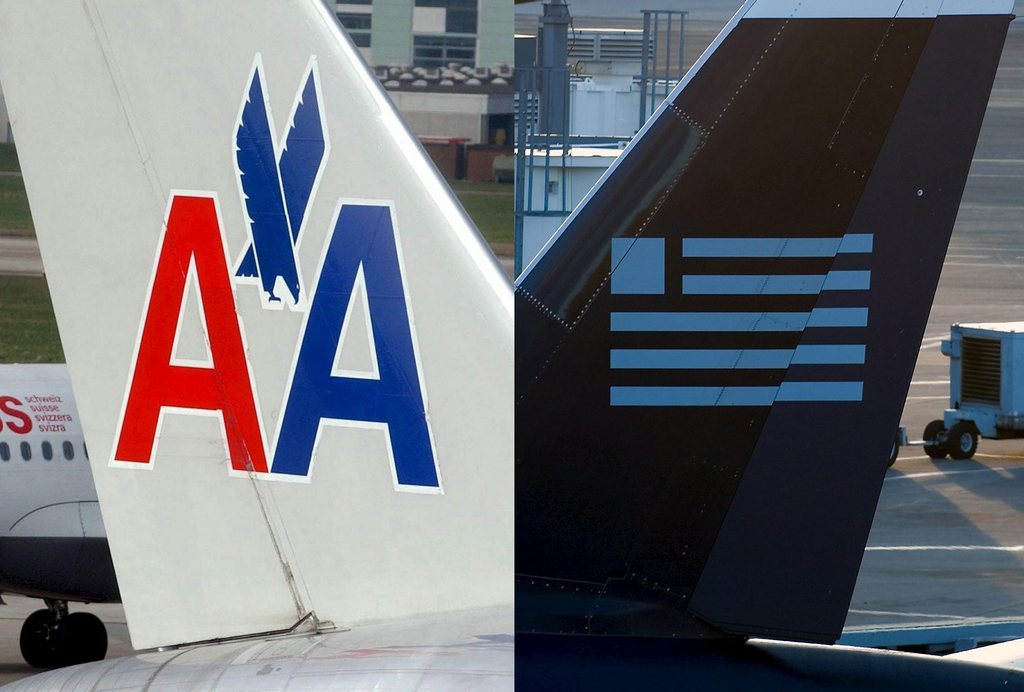 epa03582784 (FILE) A file picture combo shows the tail fins of a US Airways aircraft (R) on the terminal at Boston's Logan International Airport in Boston, Massachusetts, 19 December 2006 and an American Airlines plane in Zurich, Switzerland, 27 March 2003. According to media reports on 13 February 2012, the boards of American Airlines' parent corporation and US Airways Group have voted separately to approve a merger that will create the world's largest airline. The deal is to be officially announced early 14 February in the US, and documents with the details are to be filed with the US Bankruptcy Court in New York, USA, the same day. American Airlines declared bankruptcy in November 2011, and has continued operating under Chapter 11 bankruptcy, which grants companies protection from creditors while they reorganize their debt.  EPA/STEFFEN SCHMIDT / CJ GUNTHER