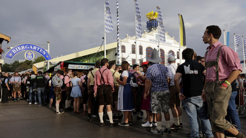 People await the opening of the 181th Oktoberfest beer festival in Munich, southern Germany, Saturday, Sept. 20, 2014. The world's largest beer festival will be held from Sept. 22 to Oct. 5, 2014. (AP Photo/Matthias Schrader)