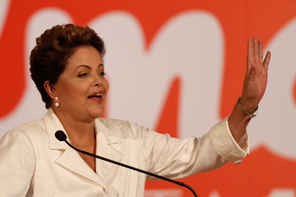 Brazil's President Dilma Rousseff, presidential candidate for re-election of the Workers Party (PT), talks about the results of the general elections during a press conference, in Brasilia, Brazil, Sunday, Oct. 5, 2014. Official results showed Sunday that President Dilma Rousseff will face challenger Aecio Neves in a second-round vote in Brazil's most unpredictable presidential election since the nation's return to democracy nearly three decades ago. (AP Photo/Eraldo Peres)