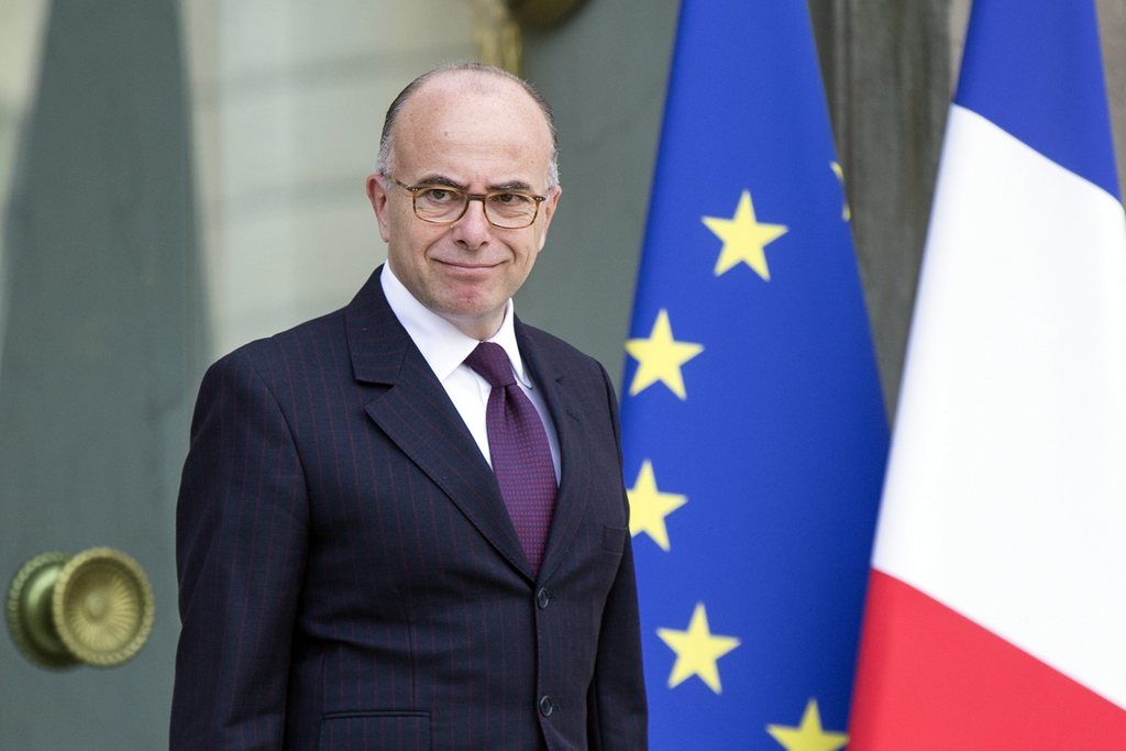 epa04416565 French Interior Minister Bernard Cazeneuve leaves the Elysee Palace after an extraordinary defense council with French President Francois Hollande in Paris, France, 25 September 2014. French President Francois Hollande said that the beheading of a French hostage in Algeria gives new urgency to stop terrorism and called on UN member states to support the fight.  EPA/ETIENNE LAURENT