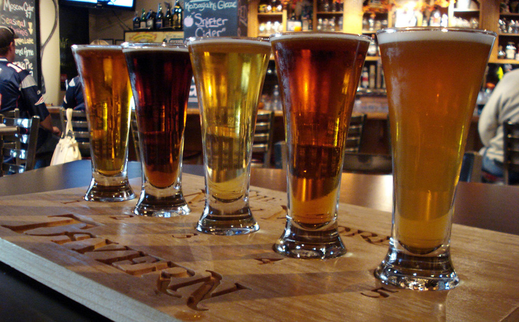 This Oct. 20, 2013, photo shows a ?beer flight?_ 4-ounce samples of five beers of a customer?s choosing _ at The New World Tavern in Plymouth, Mass. Pilgrims to ?America?s Hometown? can choose from among 32 draft brews and another 120 bottled beers at the tavern, a short walk from Plymouth Rock. It dishes up imaginative alternatives to pub grub: squash soup infused with honey and ginger and served in a champagne flute; flash-fried, kabayaki-glazed Padron peppers; and roast bone marrow and oxtail roulade. Plymouth is gearing up for hordes of hungry visitors in the run-up to 2020, when it marks the 400th anniversary of the Mayflower landing. (AP Photo/Terry Kole)
