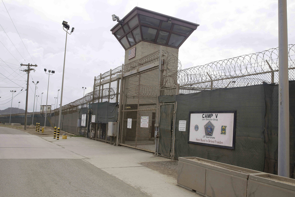 The entrance to Camp 5 and Camp 6 at the U.S. military's Guantanamo Bay detention center, which President Barack Obama has pledged to close amid opposition in Congress, at Guantanamo Bay Naval Base, Cuba, Saturday, June 7, 2014. The U.S. currently holds 149 men at Guantanamo. They include five prisoners charged with planning and aiding the Sept. 11, 2001, terrorist attack who face trial by military commission, as well as a handful of others being prosecuted. Most have been held without charge since the government began taking prisoners suspected of links to al-Qaida and the Taliban at the Navy base on the southeastern edge of Cuba in January 2002. (AP Photo/Ben Fox)