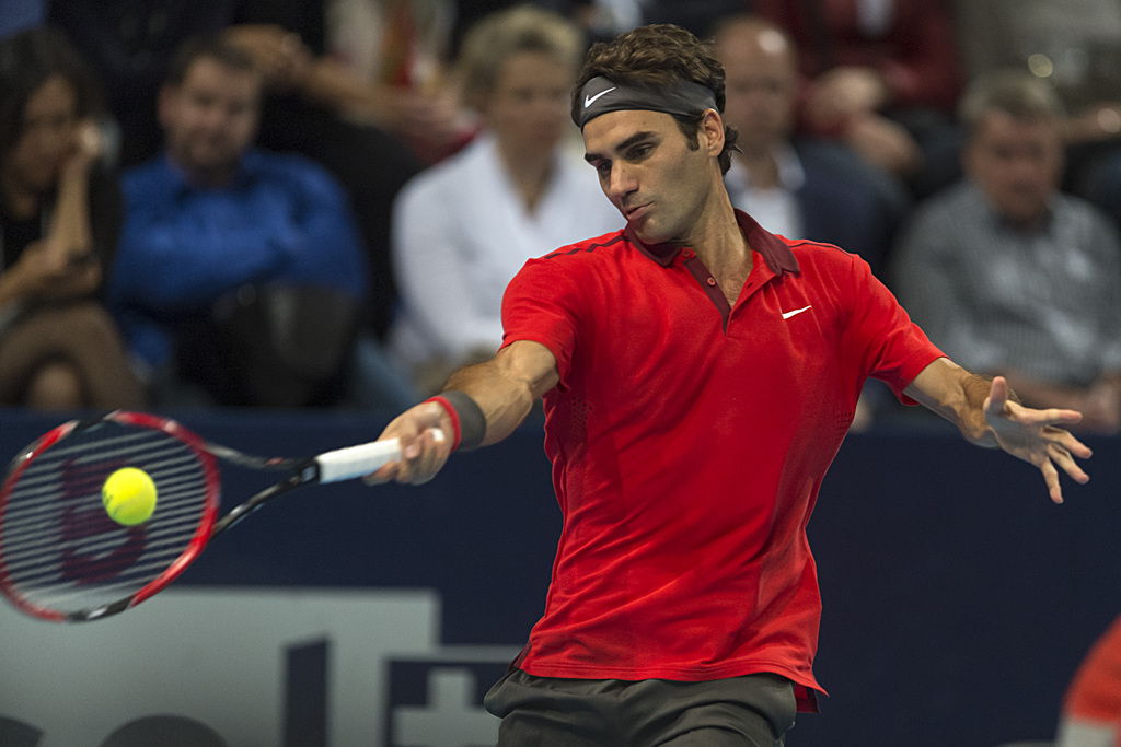 Switzerland's Roger Federer returns a ball to Belgium's David Goffin during their final match at the Swiss Indoors tennis tournament at the St. Jakobshalle in Basel, Switzerland, on Sunday, October 26, 2014. (KEYSTONE/Georgios Kefalas)