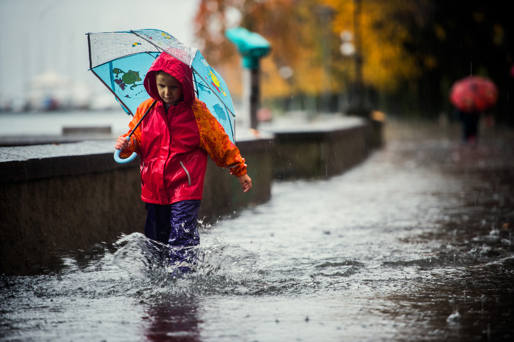 Boy Fedro walks on a flooded street in Locarno, Switzerland, Wednesday, November 12, 2014. The Southern part of Switzerland is hit with heavy rain for the last few day leading to partial floodings. (KEYSTONE/Ti-Press/Samuel Golay)
