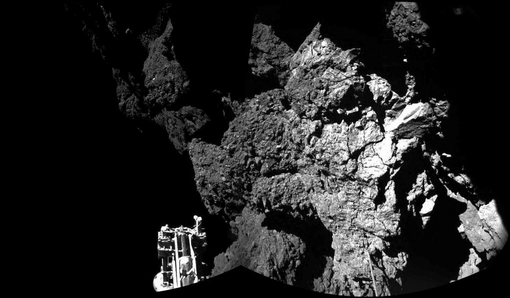 epa04487698 A handout picture made available by the European Space Agency (ESA) on 13 November 2014 and made by the CIVA camera on Rosetta's Philae lander, showing a partial view of the lander and the comet 67P/Churyumovv-Gerasimenko. ESA on 13 November 2014 confirmed Rosettas lander Philae is safely on the surface of Comet 67P/Churyumov-Gerasimenko, as the CIVA images confirm. One of the landervs three feet can be seen in the foreground. The full panoramic from CIVA will be delivered later 13 November.  EPA/ESA/Rosetta/Philae/CIVA Black and white only, HANDOUT EDITORIAL USE ONLY/NO SALES