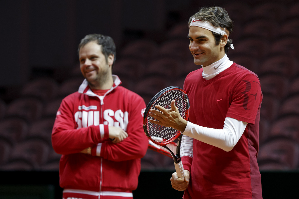 Swiss Davis Cup Team captain Severin Luethi, left, and Roger Federer, right, of Switzerland, smile during a training session of the Swiss Davis Cup Team, prior the Davis Cup Final match between France and Switzerland, in Lille, Switzerland, Thursday, November 20, 2014. The Davis Cup World Group Final France vs Switzerland will take place from 21 to November 23. (KEYSTONE/Salvatore Di Nolfi)