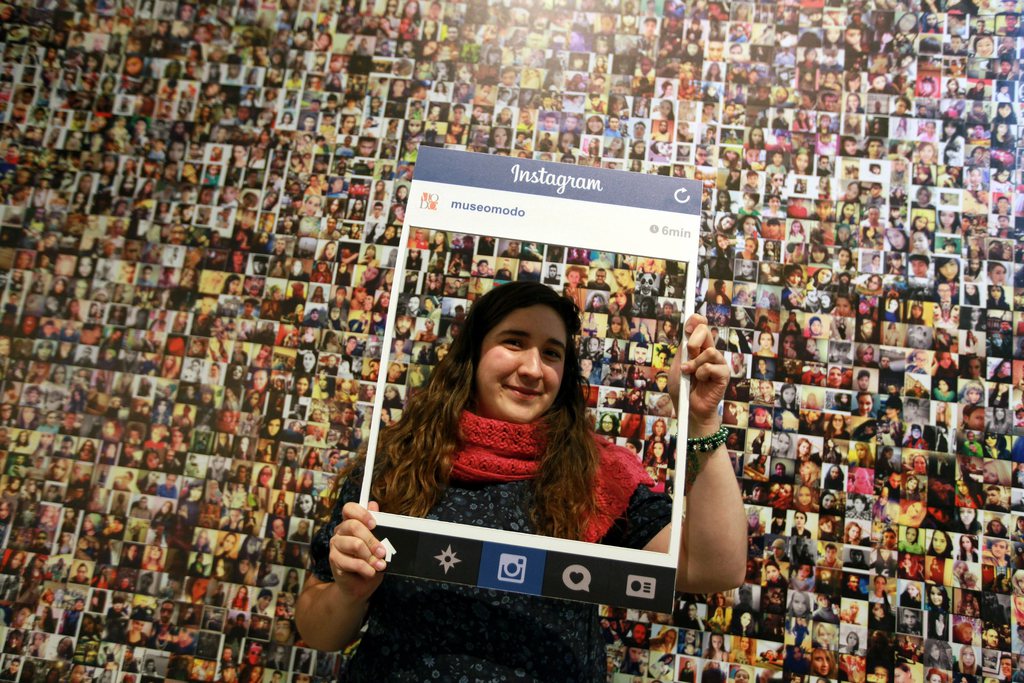 epa04505310 A woman poses with a frame of Instagram at the exhibition '175 years of photographic objects: from Daguerreotype to selfie' in Mexico City, Mexico, 26 November 2014. The exhibition displays more than 900 pictures, 150 cameras and 500 photo accessories used through history.  EPA/SASHENKA GUTIERREZ