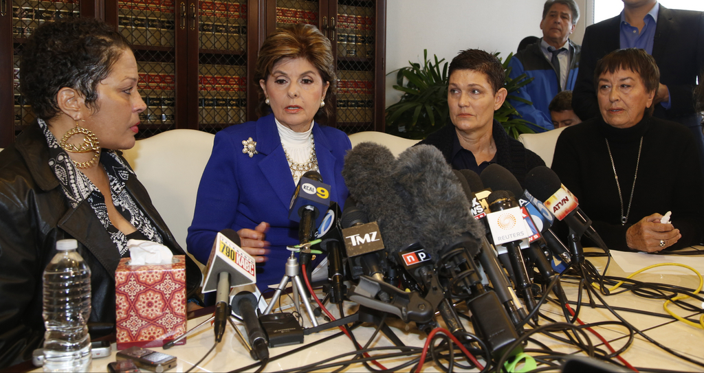 Attorney Gloria Allred, second from left, and three women who claim they were victimized by comedian Bill Cosby attend a news conference in Los Angeles on Wednesday, Dec. 3, 2014. The alleged victims are, from left, Chelan, no last name given, Beth Ferrier and Helen Hayes. In recent weeks, more than a dozen women have accused Cosby of drugging and sexually abusing them. (AP Photo/Damian Dovarganes)
