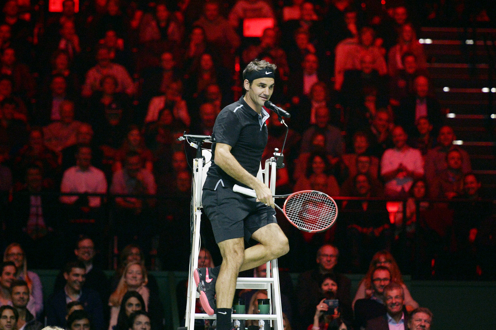 Roger Federer from Switzerland speaks to the spectators from the referee's chair during his Tennis exhibition "Match for Africa 2" against Stanislas Wawrinka in the Hallenstadion Stadium in Zurich, Switzerland, Sunday, 21 December 2014. The two Swiss tennis players compete in the charity event for the "Roger Federer Foundation" to raise money for the education of African children. (KEYSTONE/Walter Bieri)