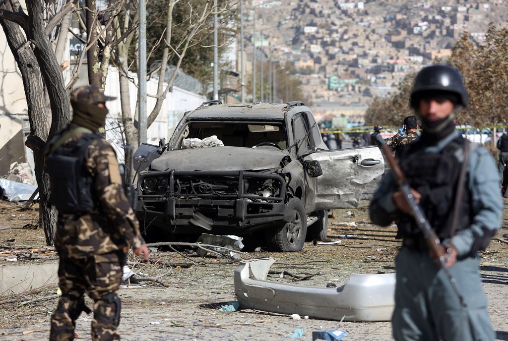 Afghan security forces inspect the site of suicide attack in Kabul, Afghanistan, Sunday, Nov. 16, 2014. A suicide bomber tried to assassinate a prominent female member of Afghanistan's parliament on Sunday, killing three people and wounding the lawmaker, a senior official said. (AP Photo/Rahmat Gul)