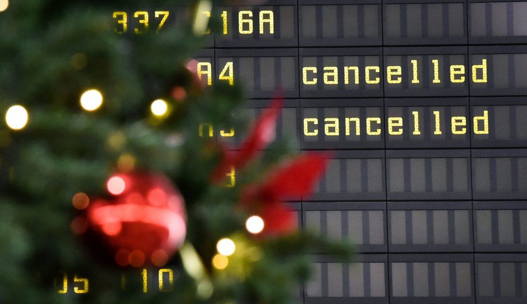 epa04510920 Flight connections are marked 'cancelled' on a flight information display board behind a seasonal Christmas decoration at the airport in Hanover, Germany, 01 December 2014. German carrier 'Lufthansa' announced to cancel about 1,350 or half its scheduled flights over the next two days after the German airline's pilots launched their ninth strike this year over a new retirement scheme. The airline said the nation-wide strike, which starts at noon (1100 GMT) on 01 December, will hit about 150,000 passengers who were scheduled to travel on the carrier's short-, medium- and long-haul flights. Cockpit, the union representing Lufthansa's 5,400 pilots, said the strike will bring to a standstill all of the airline's short- and medium-haul flights until 23.59 (22.59 GMT) on 02 December.  EPA/OLE SPATA