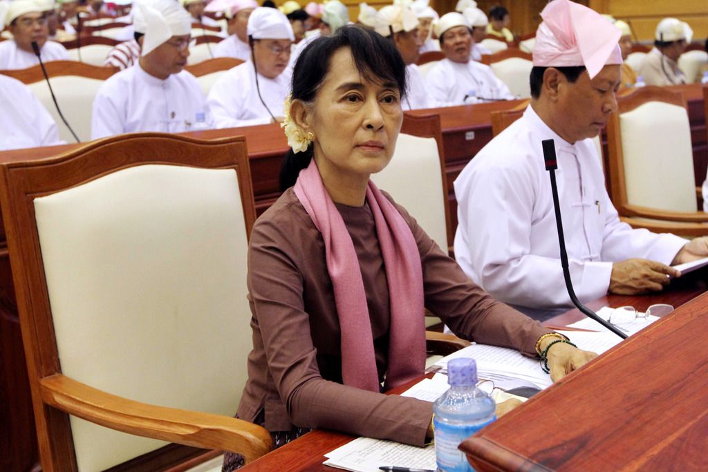FILE - In this Tuesday, Aug. 14, 2012 file photo, Myanmar's opposition leader Aung San Suu Kyi, center, attends a regular session of the parliament at Myanmar Lower House in Naypyitaw, Myanmar. (AP Photo/Khin Maung Win)