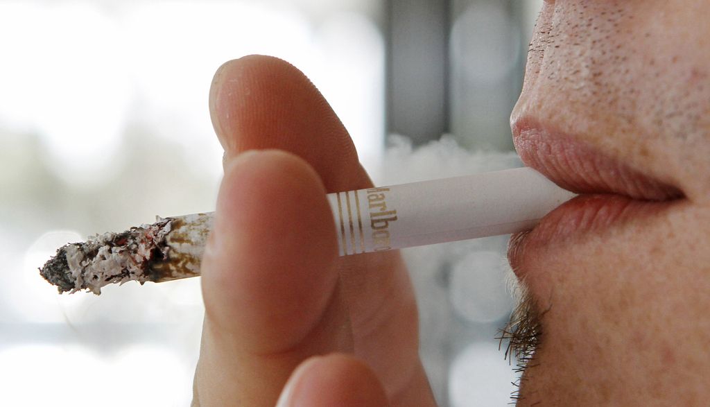 FILE - In this Feb. 7, 2011, file photo, a man smokes a Marlboro cigarette in Hialeah, Fla. A new study estimates that screening certain current and former smokers for lung cancer would cost Medicare about $2 billion a year, which would add $3 a month to Medicare premiums. (AP Photo/Alan Diaz, File)