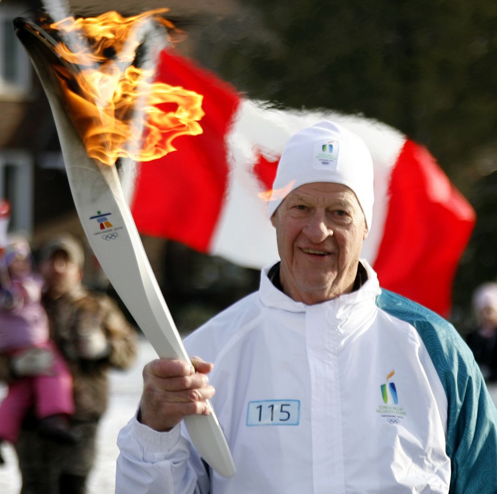 Torchbearer and Hall of Fame hockey great Gordie Howe carries the Olympic flame  in LaSalle, Ontario, on Wednesday, Dec. 23, 2009, during the 2010 Vancouver Olympics torch relay.  The 106-day relay will visit more than a thousand communities in its trip across Canada's provinces and territories by the time it reaches the opening ceremony for the Vancouver Games on Feb. 12, 2010. (AP Photo/The Canadian Press, Dave Chidley)