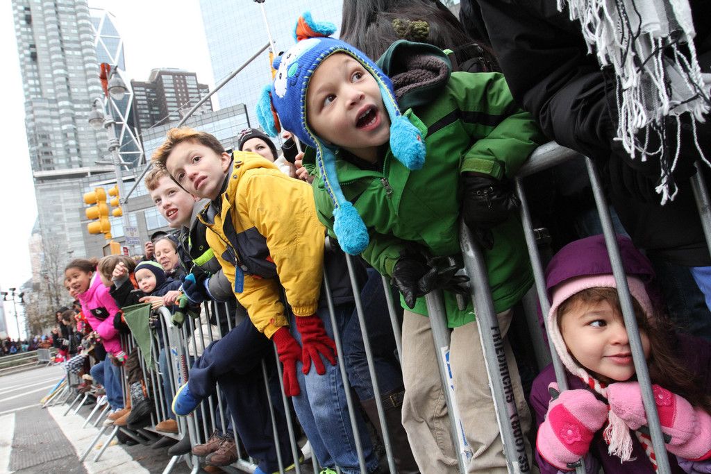 Spectators reacts as they watch the Macy's Thanksgiving Day Parade make it's way down New York's Central Park West, Thursday Nov. 27, 2014. (AP Photo/Tina Fineberg)