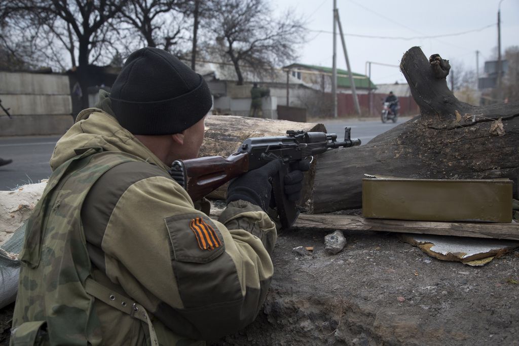 A pro-Russian rebel takes aim at a firing position at a check point not far from Donetsk airport in the city of Donetsk, eastern Ukraine Saturday, Nov. 1, 2014. Fighting intensified in the north of Donetsk between the rebels and government troops ahead of the rebel election on Sunday. (AP Photo/Dmitry Lovetsky)