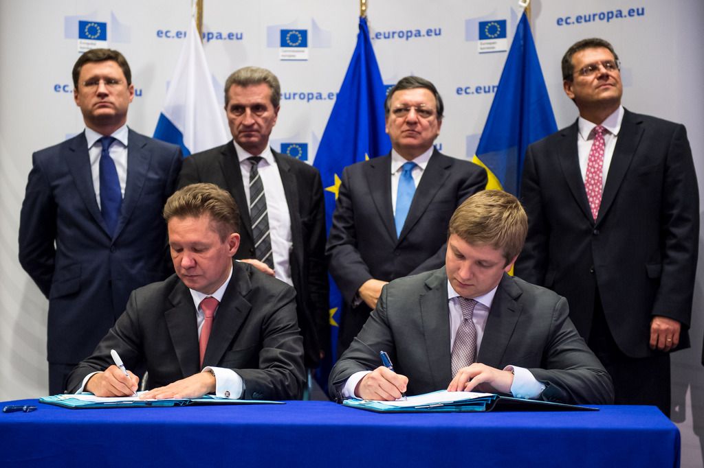 Gazprom CEO Alexey Miller, left, and Naftogaz CEO Andriy Kobolev sign an agreement that guarantees Russian gas will continue to flow to Ukraine and, by extension, parts of the EU this winter as Russian Energy Minister Alexander Novak, left back, EU Commissioner for Energy Guenther Oettinger, 2nd left back, EU Commission President Jose Manuel Barroso, 2nd right back, and EU Commissioner for Inter-Institutional Relations and Administration Maros Sefcovic look on, at the European Commission headquarters in Brussels, Thursday, Oct. 30, 2014. (AP Photo/Geert Vanden Wijngaert)