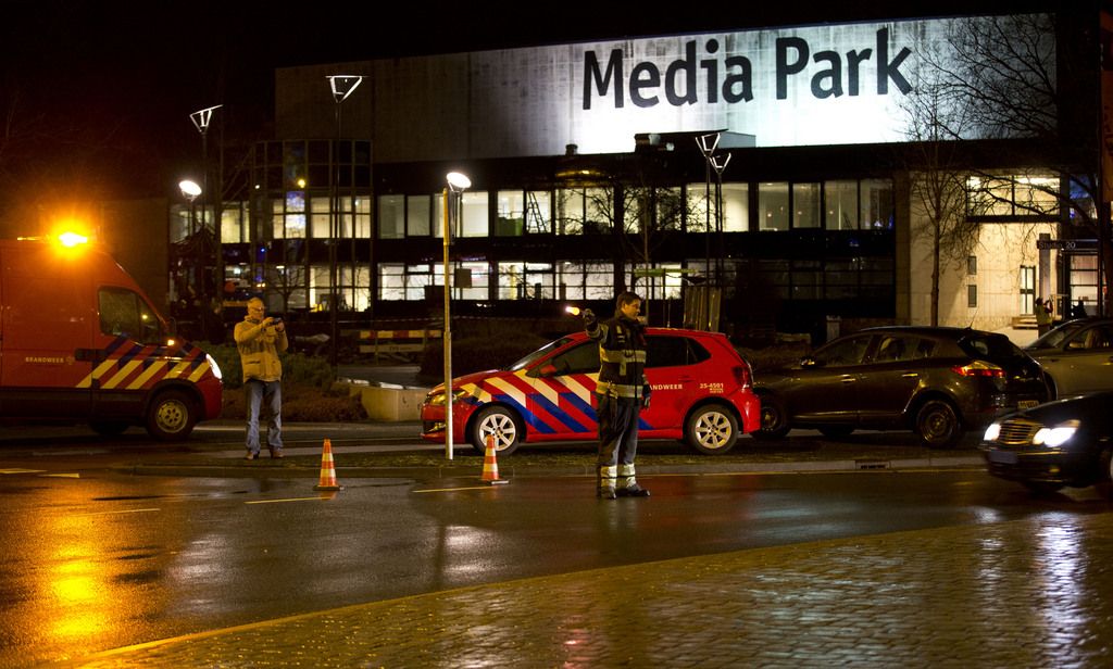 Security forces are seen outside the Media Park in Hilversum, Netherlands, Thursday, Jan. 29, 2015. A gunman entered the headquarters of Dutch national broadcaster NOS outside Amsterdam on Thursday and demanded airtime on television, before being detained, company officials said. Jan de Jong, director of the NOS, told national radio "Someone got into the building" and added that the man had been taken into custody.(AP Photo/Peter Dejong)