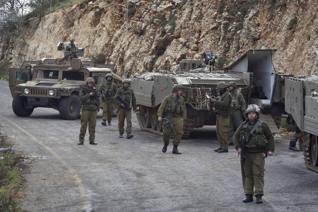 Israeli soldiers secure the Israel-Lebanon Border, Wednesday, Jan. 28, 2015. The Lebanese Hezbollah group is claiming responsibility for today?s attack on an Israeli military convoy. Hezbollah claims the attack destroyed a number of Israeli vehicles and caused casualties among "enemy ranks." Israel later fired at least 35 artillery shells into Lebanon. (AP Photo/Ariel Schalit)
