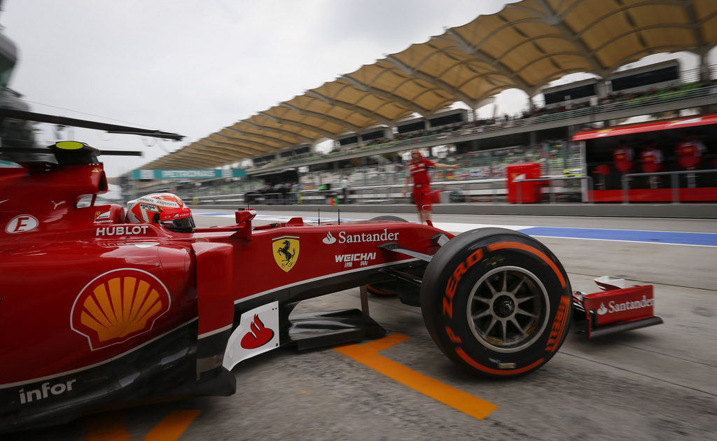 Ferrari driver Kimi Raikkonen of Finland leaves the pit area during third practice session for the Malaysian Formula One Grand Prix at Sepang International Circuit in Sepang, Malaysia, Saturday, March 29, 2014. (AP Photo/Vincent Thian)