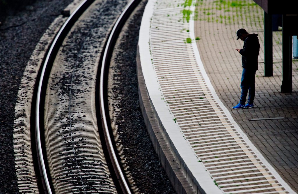epa04477437 A man stands on the platform waiting for the arrival of a train on the train station in Seelze, Germany, 05 November 2014. Germany's Deutsche Bahn is considering launching legal action against train drivers' union GDL as the railway company braces itself for the longest strike in its 20-year history. The strike announcement on 04 November triggered condemnation from both business and political leaders.  EPA/JULIAN STRATENSCHULTE