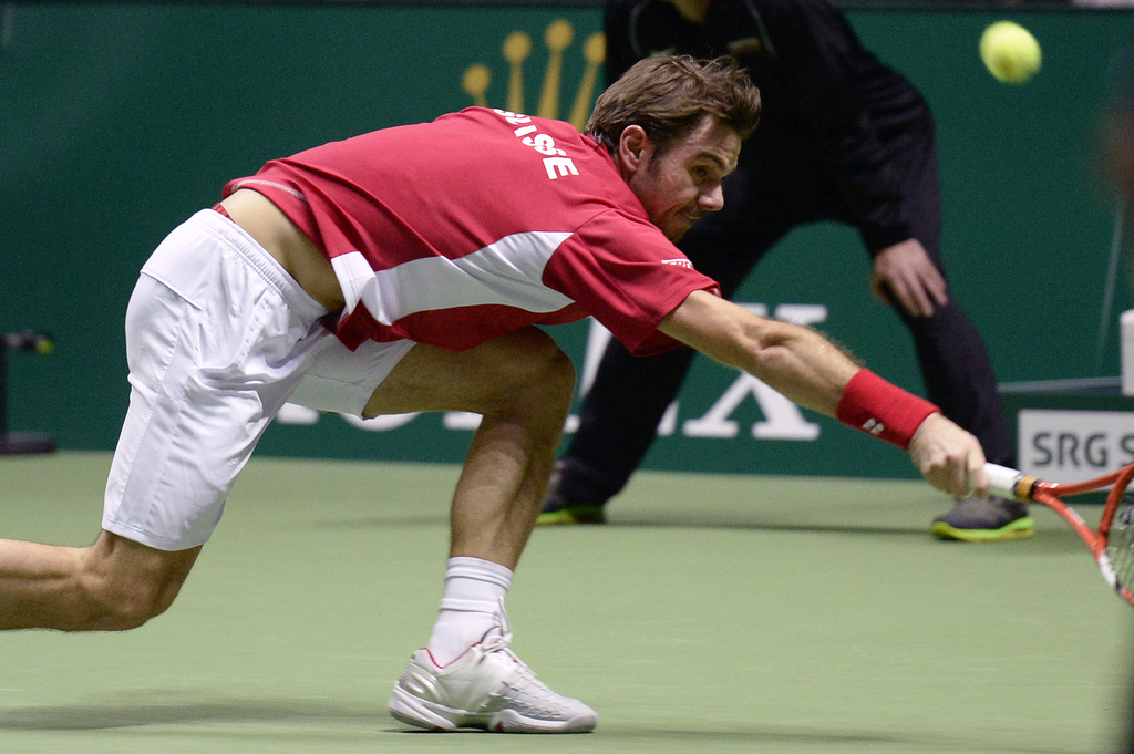 Stanislas Wawrinka from Switzerland plays the ball to Roger Federer from Switzerland, during the Tennis exhibition "Match for Africa 2" in the Hallenstadion Stadium in Zurich, Switzerland, Sunday, 21 December 2014. The two Swiss tennis players compete in the charity event for the "Roger Federer Foundation" to raise money for the education of African children. (KEYSTONE/Walter Bieri)