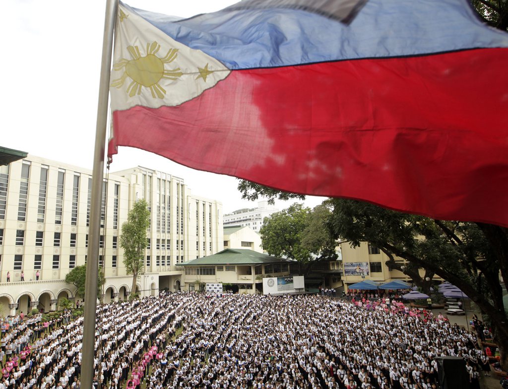 epa04617285 Hundreds of Filipino students, teachers and nuns dance, under a Philippines flag, during the 'One Billion Rising Dance' to demand an end to violence against women and girls, inside an all-girl catholic school in Manila, Philippines, 13 February 2015. Girls are at an increasing risk of violent attacks simply because they are getting an education, the UN human rights office said. Many attacks on schools that have been recorded in 70 countries from 2009 to 2014 were specifically targeting girls, the Office of the UN High Commissioner for Human Rights said.  EPA/RITCHIE B. TONGO