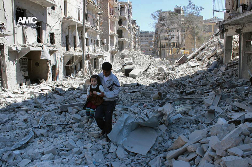 FILE -- In This April 21, 2014, file photo, provided by the anti-government activist group Aleppo Media Center (AMC), which has been authenticated based on its contents and other AP reporting, shows a Syrian man holding a girl as he stands on the rubble of houses that were destroyed by Syrian government forces air strikes in Aleppo, Syria. Nearly four years since it began, Syria?s civil war has defied all diplomatic attempts to broker a peaceful resolution _ and the fierce fighting still goes on daily, though it has taken a back seat to the rampage in the region by Islamic State militants. (AP Photo/Aleppo Media Center AMC, File)