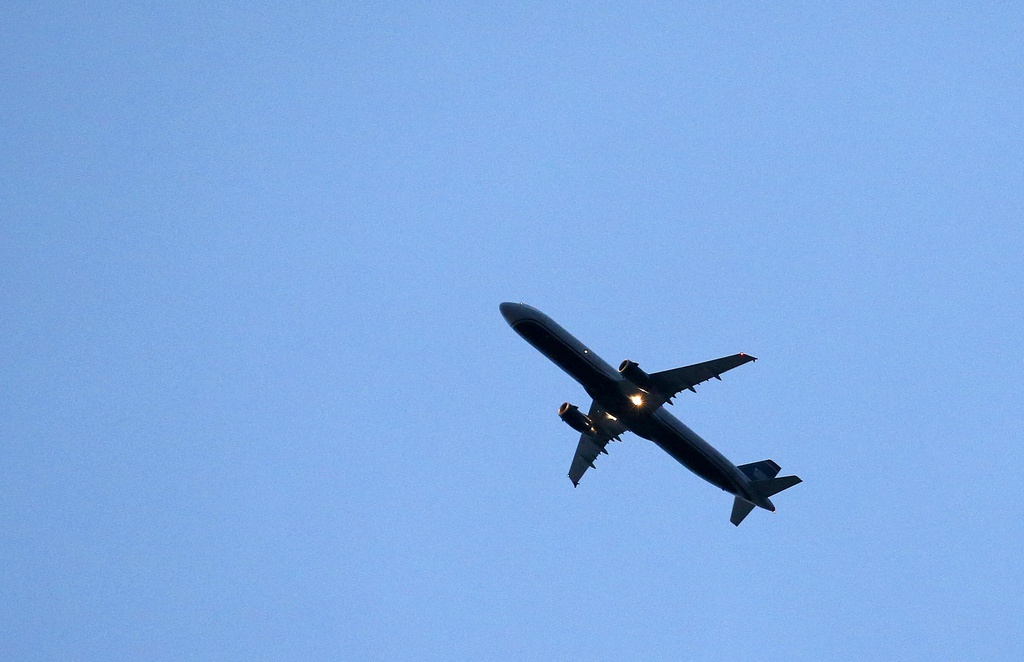 A passenger plane flies directly over a home as it brings increased noise to residential neighborhoods like this one near Phoenix as new FAA flight routes out of Phoenix Sky Harbor International Airport are affecting dozens of neighborhoods with the new noise that residents previously did not have to be subjected to Friday, Feb. 20, 2015, in Laveen, Ariz. (AP Photo/Ross D. Franklin)