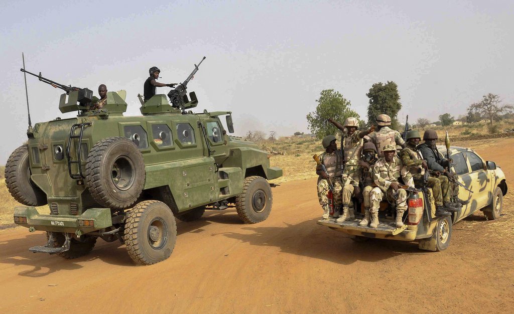 epa04653431 A photograph made available 08 March 2015 shows the Nigerian army patroling in Chibok, Borno State, North Eastern Nigeria 05 March 2015.  According to reports two busy markets and a bus station wre the targets of an alleged Boko Haram suicide attack which killed 54 people and injured 143 in the city of Maiduguri in north-eastern Nigeria 07 March 2015.  EPA/Henry Ikechukwu