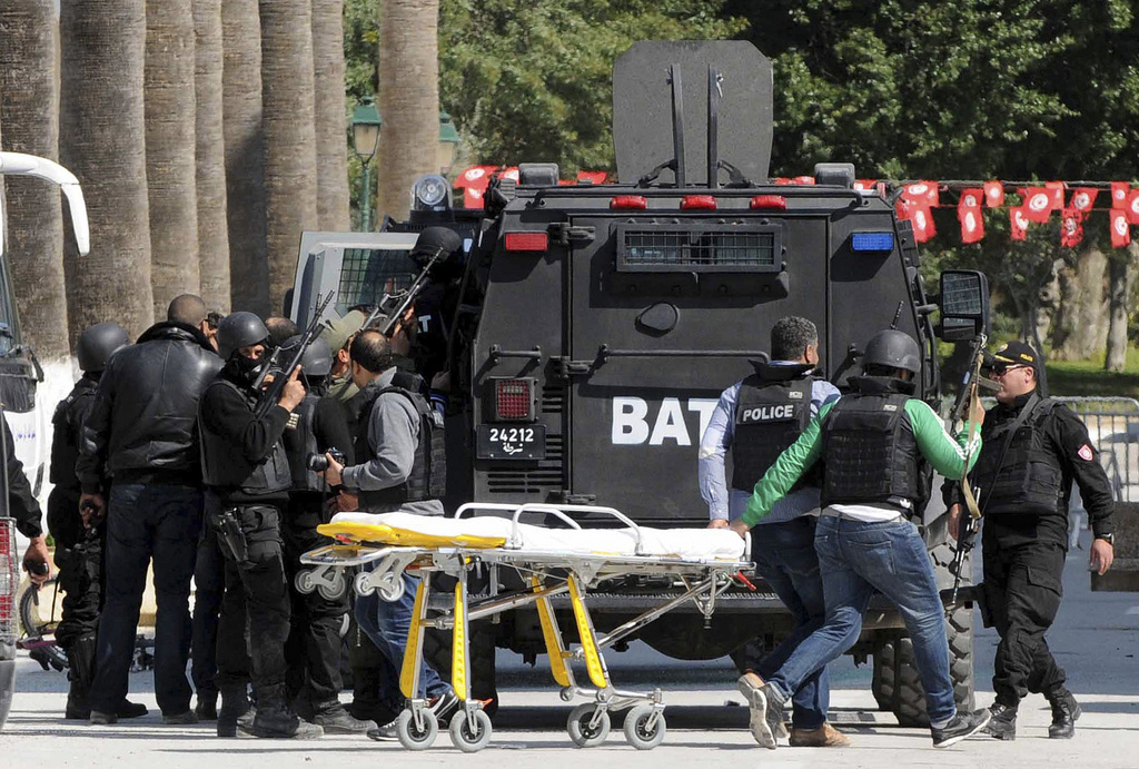 Rescue workers pull an empty stretcher after gunmen opened fire at the Bardo museum in Tunisia's capital, Wednesday, March 18, 2015 in Tunis. Authorities say scores of people are dead after an attack on a major museum in the Tunisian capital, and some of the gunmen may have escaped. (AP Photo/Ali Ben Salah)