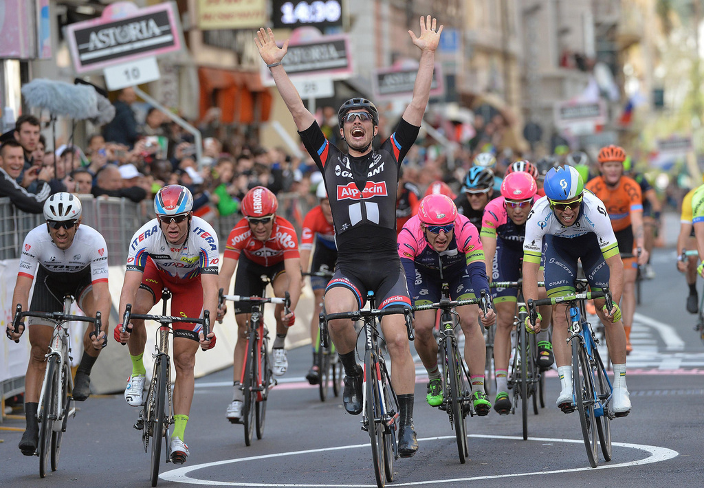 John Degenkolb of Germany reacts as he crosses the finish line to win the Milan-San Remo classic in San Remo, Italy, Sunday, March 22, 2015, edging defending champion Alexander Kristoff on a wet and rainy course for the biggest win of his career. Degenkolb burst through the middle in the closing meters to win the 293-kilometer (182-mile) race in 6 hours, 46 minutes, 16 seconds after Kristoff had started his sprint too early. (AP Photo/Luca Zennaro, Ansa)  ITALY OUT