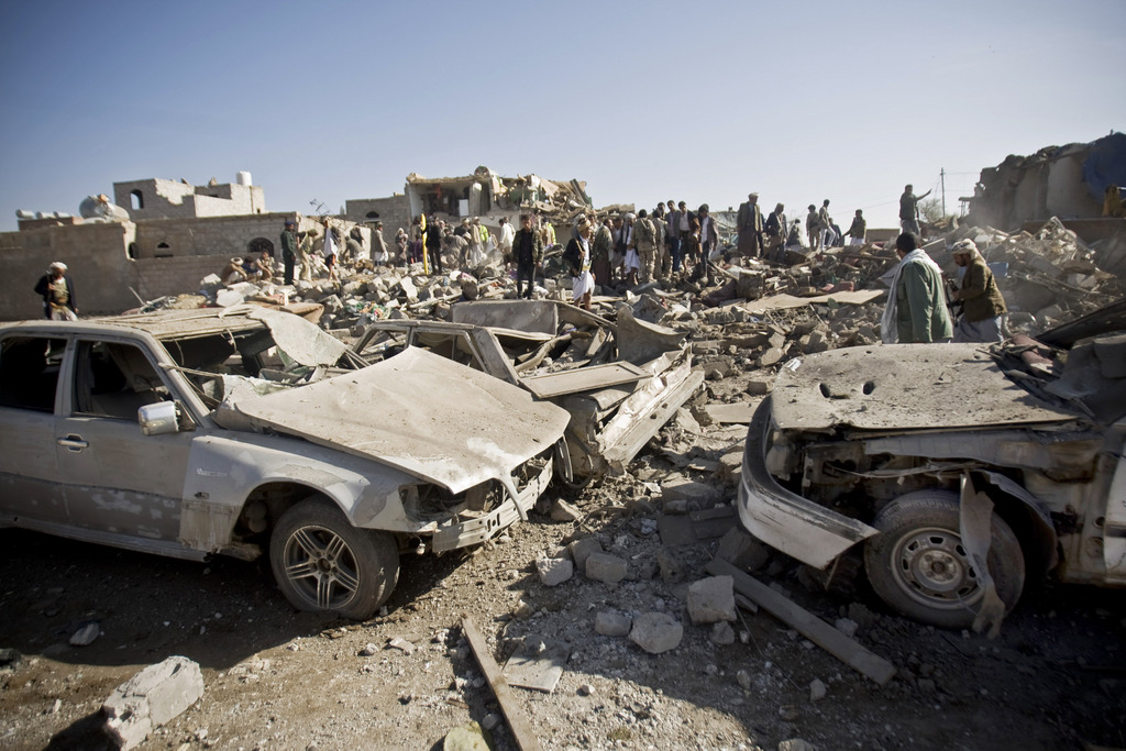 People search for survivors under the rubble of houses destroyed by Saudi airstrikes  near Sanaa Airport, Yemen, Thursday, March 26, 2015. Saudi Arabia launched airstrikes Thursday targeting military installations in Yemen held by Shiite rebels who were taking over a key port city in the country's south and had driven the embattled president to flee by sea, security officials said. (AP Photo/Hani Mohammed)