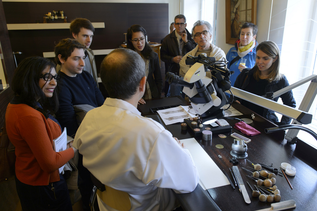 Un maître graveur de la nanufacture Vacheron Constantin explique ici son métier à des visiteurs à Genève.
