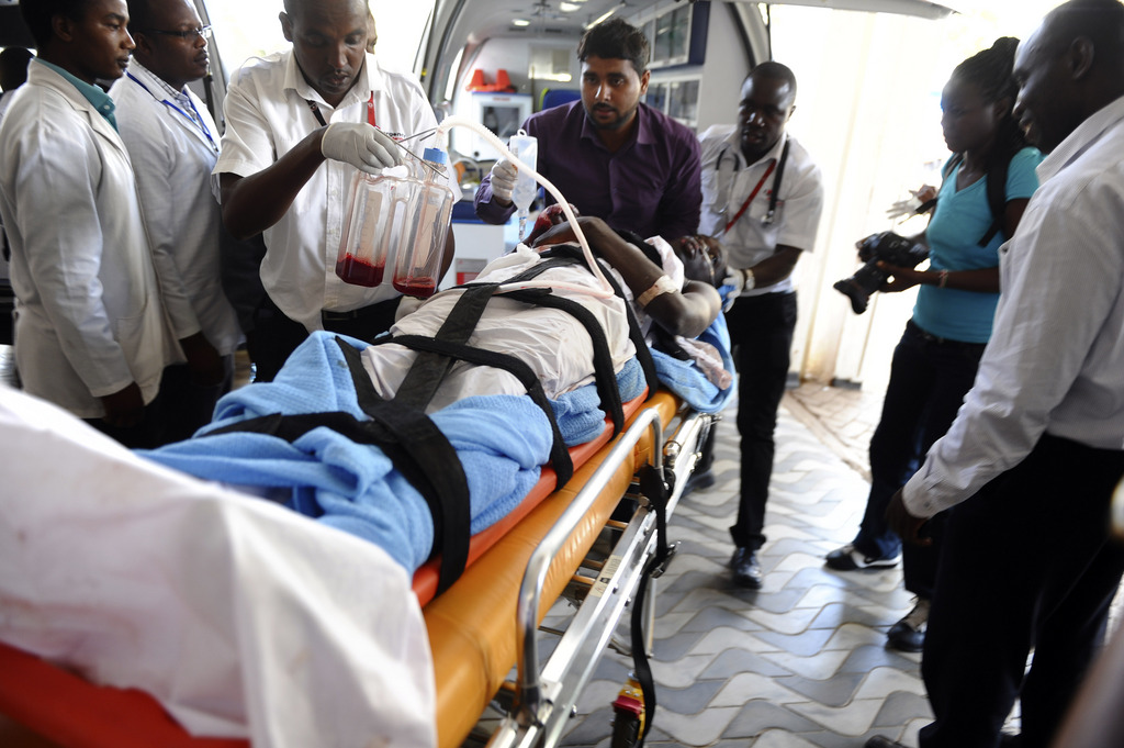 Medics help an injured person at Kenyatta national  Hospital in Nairobi, Kenya, Thursday, April , 2, 2015 , after being airlifted from Garissa after an attack by gunmen at Garissa University College in northeastern Kenya on Thursday morning. Al-Shabab gunmen attacked Garissa University College in northeast Kenya early Thursday, targeting Christians and killing at least 15 people and wounding 60 others, witnesses said. (AP Photo)