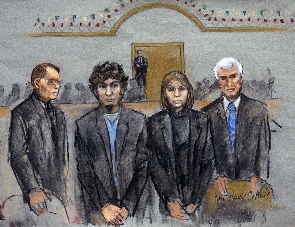 In this courtroom sketch, Dzhokhar Tsarnaev, second from left, is depicted standing with his defense attorneys as the jury presents its verdict in his federal death penalty trial Wednesday, April 8, 2015, in Boston. Tsarnaev was convicted on multiple charges in the 2013 Boston Marathon bombing. Three people were killed and more than 260 were injured when twin pressure-cooker bombs exploded near the finish line. (AP Photo/Jane Flavell Collins)