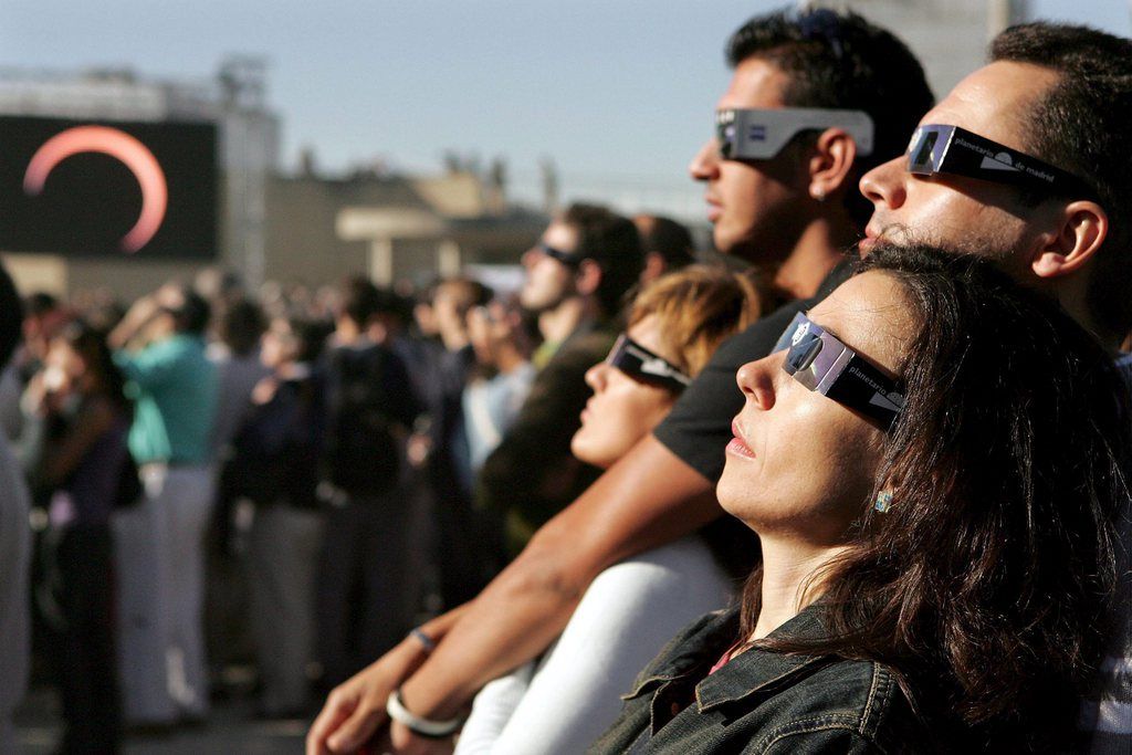 People use special glasses to watch the moon pass between the earth and the sun to cause an annular solar eclipse over Madrid 03 October 2005. An annular eclipse differs from a total eclipse in that the moon appears too small to completely cover the sun. As a result, the moon is surrounded by an intensely brilliant ring or annulus formed by the outer perimeter of the sun's disk. The last annular eclipse visible from Spain took place on the 1st of April 1764 and the next one will occur on the 26th of January 2028.  EPA/FERNANDO ALVARADO