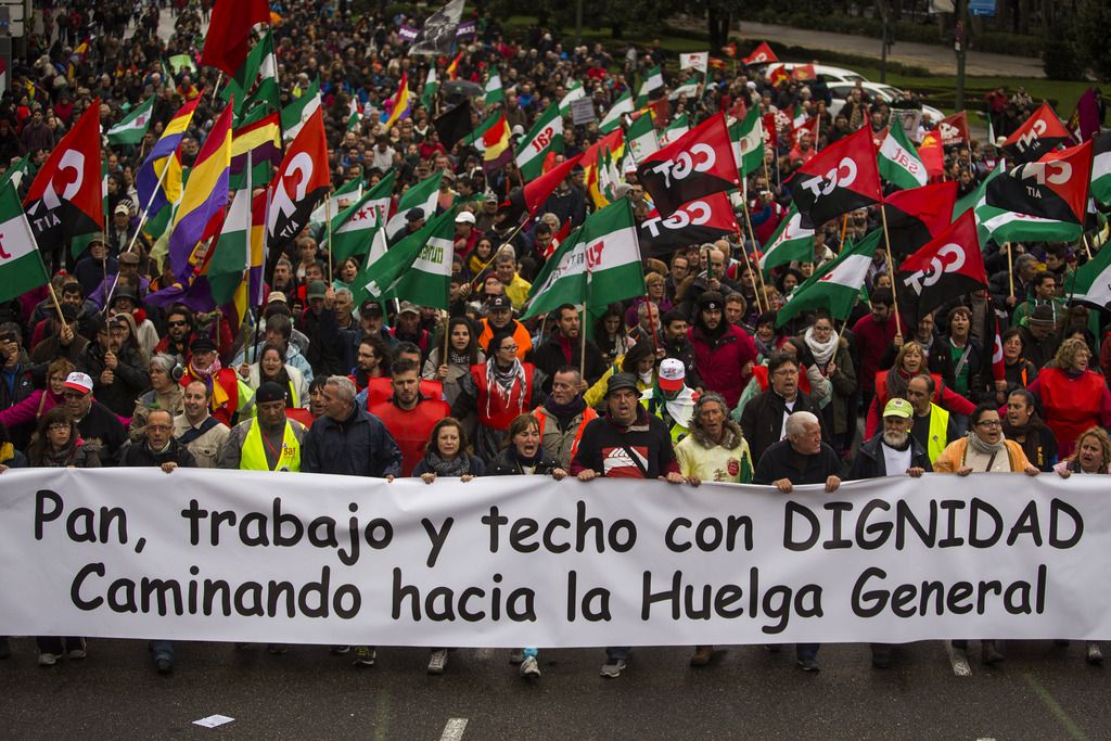 Protestors carry banners reading "Food, jobs and a roof with dignity. Working for a general strike" during a "Dignity March" to protest against the Government in Madrid, Spain, Saturday, March 21, 2015. Thousands from different parts of Spain marched towards the Capital to join a large anti-austerity demonstration to express their anger at government financial cuts, its housing rights policies, and the high unemployment rates and to protest the Transatlantic Trade and Investment Partnership (TTIP) a proposed free trade agreement between the European Union and the United States. (AP Photo/Andres Kudacki)