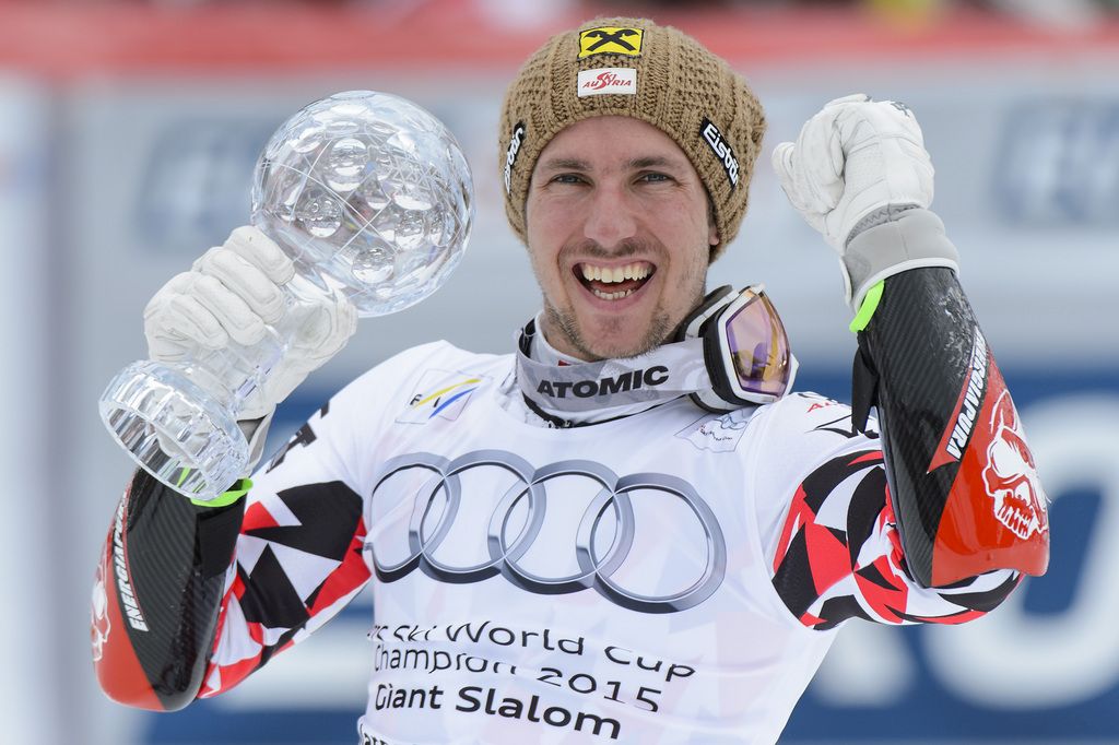 Marcel Hirscher of Austria celebrates with the crystal globe winning the overall men's Super-G competition during the second run of the men's Giant-Slalom race of the FIS Alpine Skiing World Cup Finals, in Meribel, France, Saturday, March 21, 2015. (KEYSTONE/Jean-Christophe Bott)