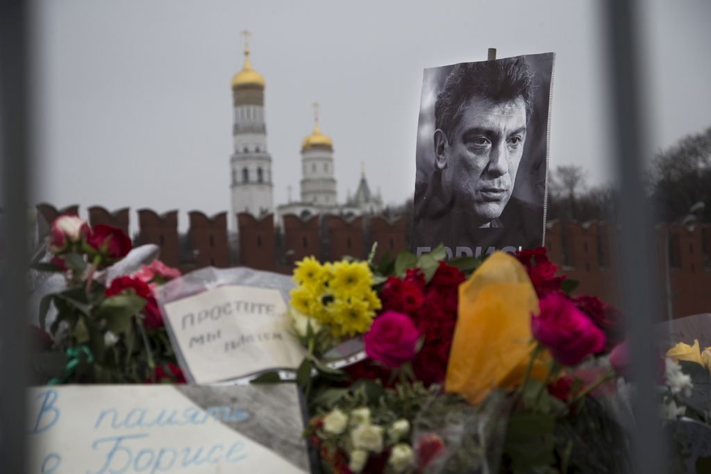 Flowers and a condolence message that reads "In memory of Boris" are placed with a portrait of Boris Nemtsov, a charismatic Russian opposition leader and sharp critic of President Vladimir Putin, at the site where Nemtsov was gunned down near the Kremlin, against a backdrop of the Kremlin Wall, in Moscow, Russia, Monday, March 2, 2015. Nemtsov was killed on Friday, Feb. 27 in what many in the opposition believe was reprisal for his unrelenting criticism of Putin. No suspects have yet been detained in connection with the killing. (AP Photo/Ivan Sekretarev)